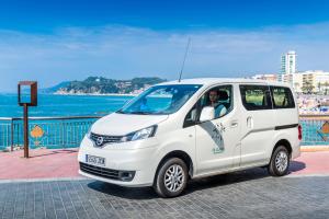 a white van parked next to the ocean at Apartaments Els Llorers in Lloret de Mar