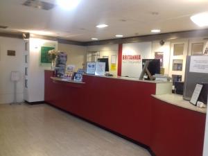 a cashier counter in a store with a red at The Britannia Nottingham Hotel in Nottingham