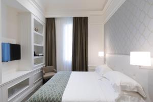 Postel nebo postele na pokoji v ubytování Grand Hotel Palace