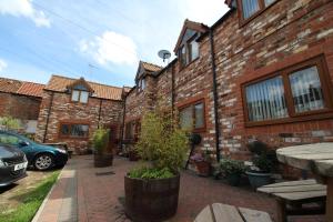 a brick building with a car parked in front of it at Albion Cottages in Bridlington