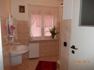 a bathroom with a toilet and a sink and a window at Nad Krolówką in Ustrzyki Dolne