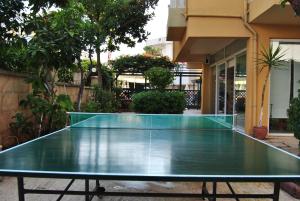 a ping pong table in front of a building at Benna Hotel in Antalya