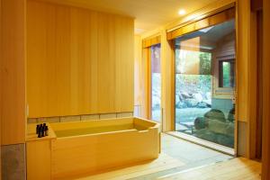 a bathroom with a tub and a sink at okcs Retreat Hakone villa in Hakone