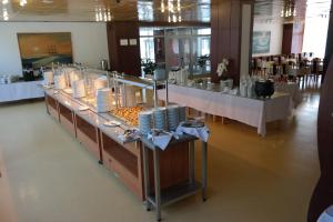 a buffet line in a room with white tables at OSW Kaper in Jurata