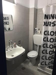 a bathroom with a white toilet and a sink at Helios Hotel in Agia Marina Aegina