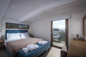 a bedroom with a bed and a window at Diamond Village & Suites in Hersonissos
