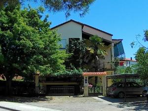 a house with a car parked in front of it at Lea Apartment in Umag