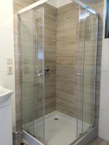 a shower with a glass enclosure in a bathroom at Domki pokoje pod Wierzba in Sarbinowo +24 photos