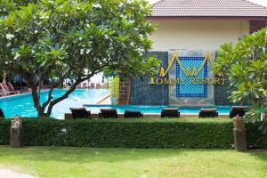 a swimming pool with chairs in front of a resort at Tommy Resort in Haad Rin