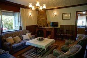 a living room with a couch and a fireplace at Casa Gayol in El Franco
