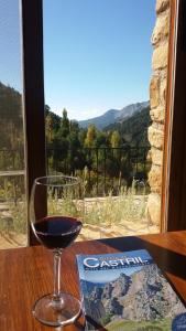 a glass of wine sitting on a table with a view at Saluda Alta in Castril +38 photos