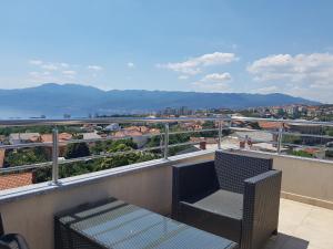 a balcony with a bench and a view of the city at Peachy House in Rijeka