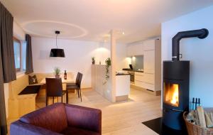 a living room with a fireplace and a dining room at Montafon Chalets in Gaschurn