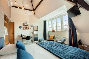 a bedroom with a large bed and a desk at La Paulowna Boutique Hotel in The Hague