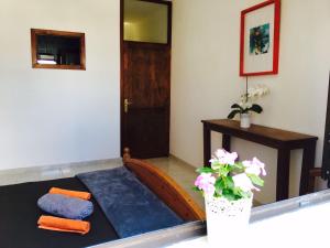 a room with a bed and a door and a plant at La Santa Feel Good in La Santa