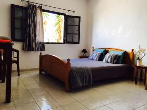 a bedroom with a bed and a window at La Santa Feel Good in La Santa