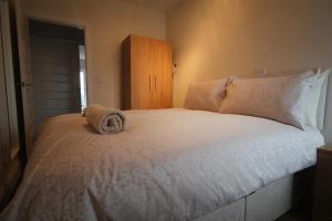 a bed with a stuffed animal on top of it at Sea View Apartments in South Shields