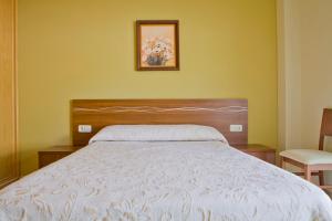 Łóżko lub łóżka w pokoju w obiekcie Sanxenxorural - Apartamentos La Rana