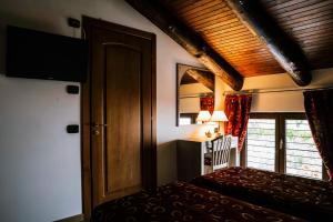a room with a bed and a door and a window at Agriturismo Cascina del Vai in Cairo Montenotte +60 photos