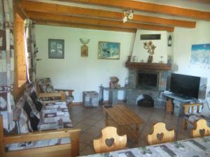 a living room with a table and a fireplace at Chalet les Gentianes in Les Coches