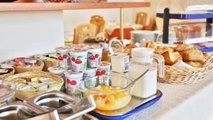 a table with a bunch of food and baskets of bread at Hotel Europa in Pforzheim