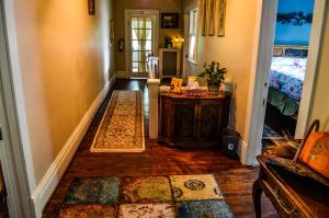 a hallway of a home with a table and a bed at Greenwood Bed & Breakfast in Greensboro