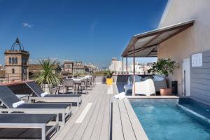 a swimming pool on the roof of a building at Enjoybcn Miro Apartments in Barcelona