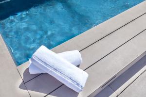 a towel sitting on a bench next to a swimming pool at Enjoybcn Miro Apartments in Barcelona