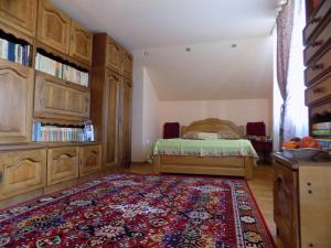 a bedroom with a bed and a rug at Casa Teo in Hunedoara