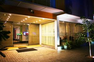 a lobby of a building at night with plants at Hasara Hotel Galle in Galle