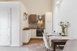 a kitchen and dining room with a table and chairs at Miramonte Holiday in Montescaglioso