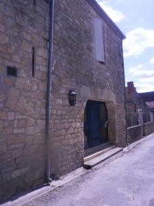 a brick building with a large door on the side of it at Maison Lambert in Domme