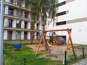 a playground in front of a building at Apartament 505 in Mielno