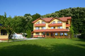a large building with a lawn in front of it at Vila Maria Snagov in Snagov