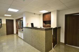 an office lobby with a counter with a laptop on it at Vila Maria Snagov in Snagov +86 photos