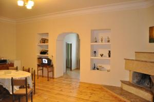 a living room with a table and a fireplace at Apartment Chavchavadze 5 in Sighnaghi