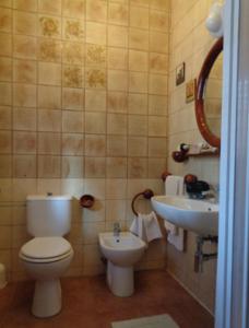 a bathroom with a toilet and a sink at Affittacamere La Camelia in Lucca