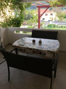 a table on a balcony with a table and chairs at Apartments Bruno in Jurandvor