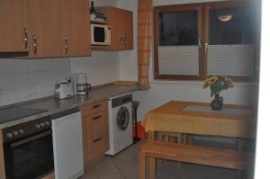 a kitchen with wooden cabinets and a counter top at Haus Waldblick in Hagen