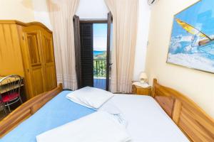 a bedroom with a bed with a view of the ocean at Apartments Milena in Rtina