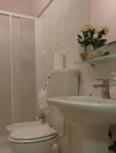 a bathroom with a toilet and a sink at Affittacamere La Camelia in Lucca