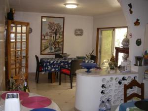 a kitchen with a table and a dining room at Monte da Ria Guest House in Faro