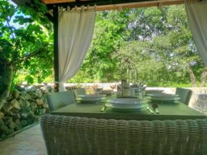a table with a green table cloth on a patio at Holiday House Little Precious in Sveti Anton
