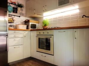 a kitchen with white cabinets and a microwave at Holiday House Little Precious in Sveti Anton