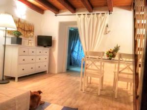 a living room with a table and a dog laying on the floor at Holiday House Little Precious in Sveti Anton