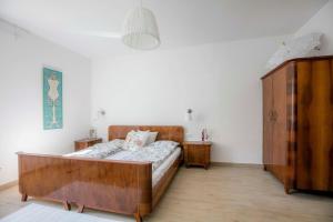 una camera con letto in legno e armadio di Season4All Apartments a Mali Lošinj (Lussinpiccolo)
