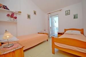 Postel nebo postele na pokoji v ubytování Apartment Ksenija
