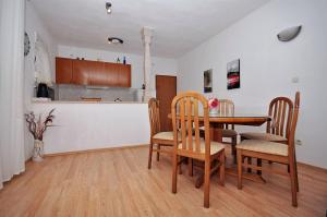 a kitchen and dining room with a table and chairs at Apartment Katija in Postira