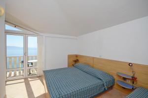 Postel nebo postele na pokoji v ubytování Apartments Jure