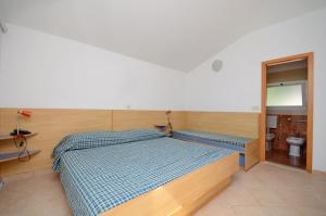 Postel nebo postele na pokoji v ubytování Apartments Jure